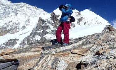 Trekker capturing the snowy peaks of Mount Makalu during the Makalu View Trek in eastern Nepal
