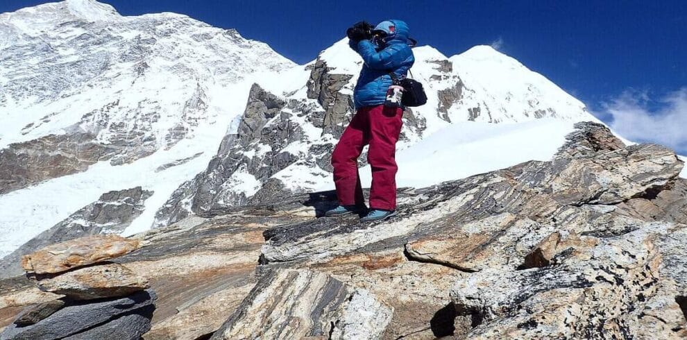 Trekker capturing the snowy peaks of Mount Makalu during the Makalu View Trek in eastern Nepal