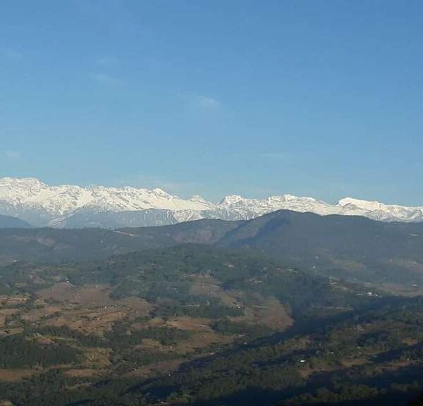Panoramic view of snow-capped Himalayan peaks seen during a One Day Sightseeing Tour in eastern Nepal.