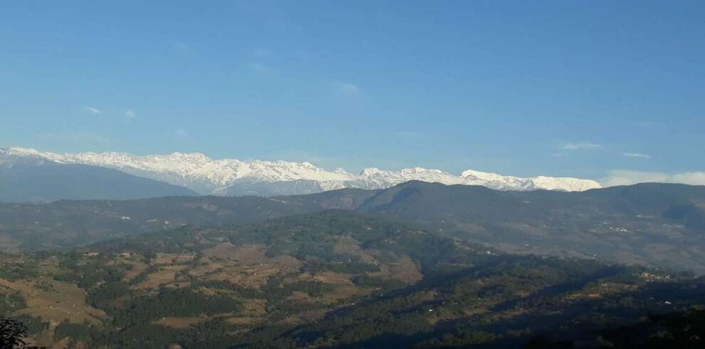 Panoramic view of snow-capped Himalayan peaks seen during a One Day Sightseeing Tour in eastern Nepal.