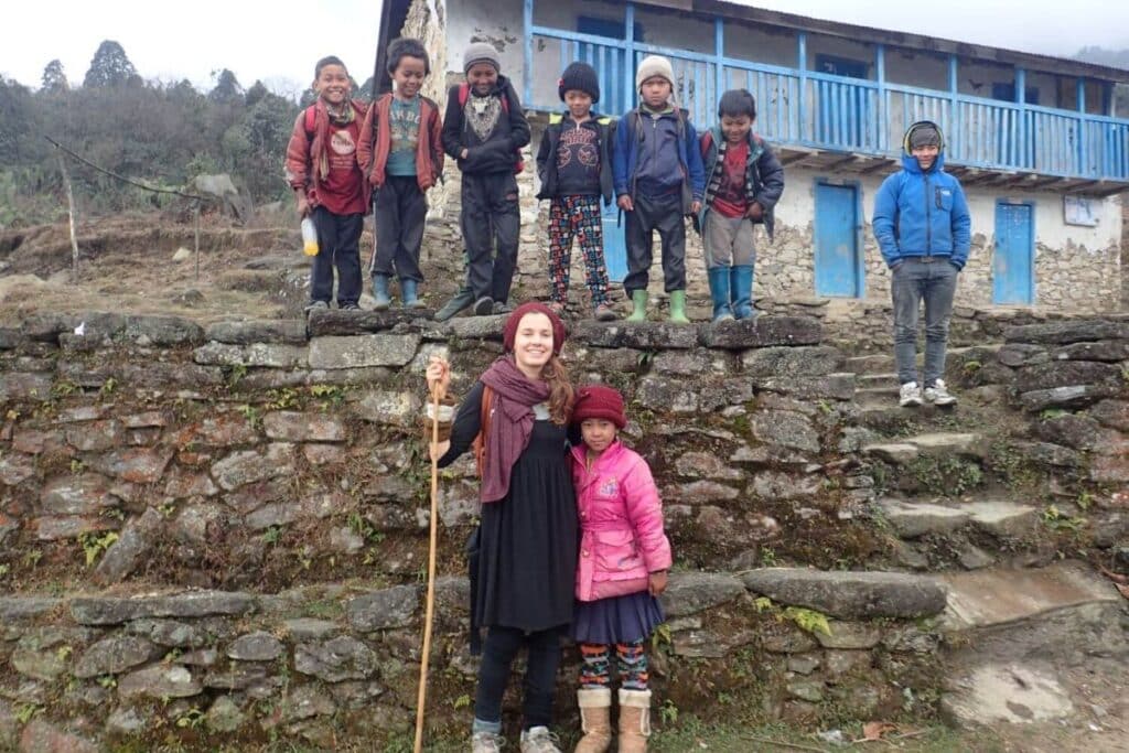 A guest visiting a local school during a community-based trekking experience in Nepal