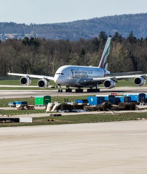 An Emirates aircraft taxiing on the runway, a common starting point for travelers heading toward the Lukla Makalu Base Camp trek route