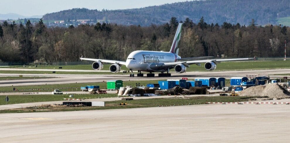 An Emirates aircraft taxiing on the runway, a common starting point for travelers heading toward the Lukla Makalu Base Camp trek route