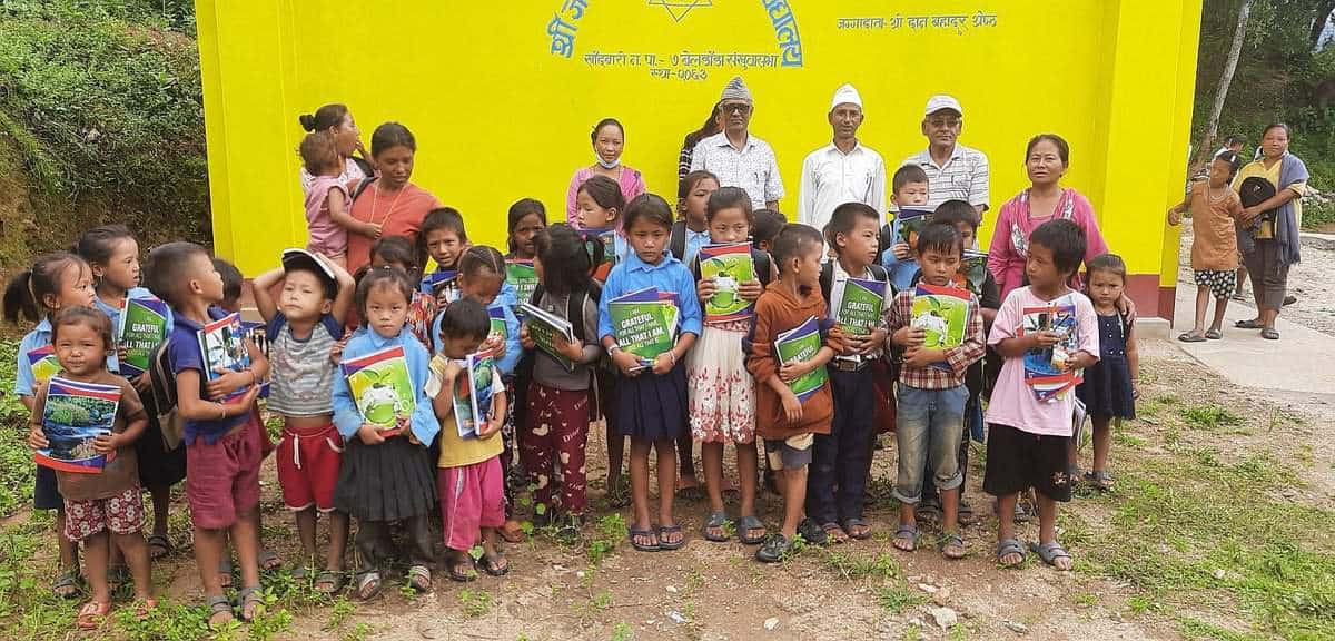 Children receiving school supplies as part of a MAST Community Projects in Nepal.”