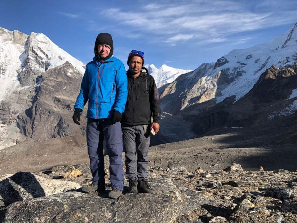 A trekker with a local porter guide having Makalu Base Camp Trek supporting Makalu Trekking for Social Impact.