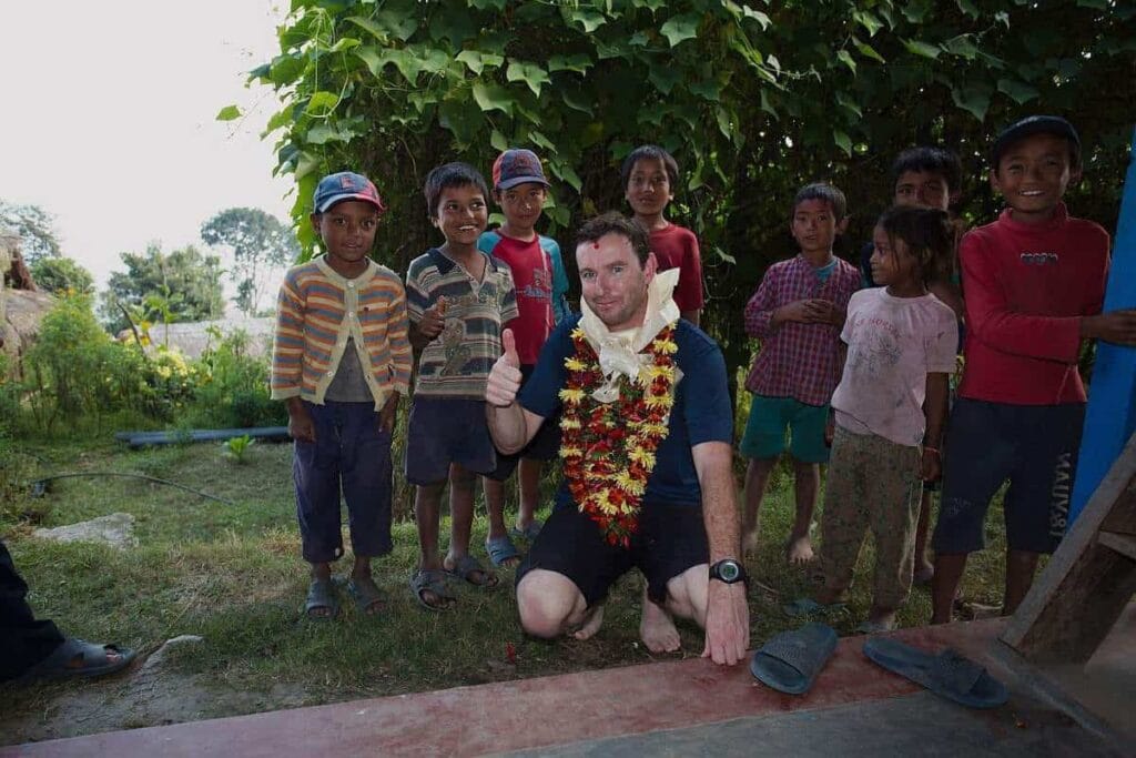Volunteer Michael with schoolchildren during a school visit near Khandbari, Nepal