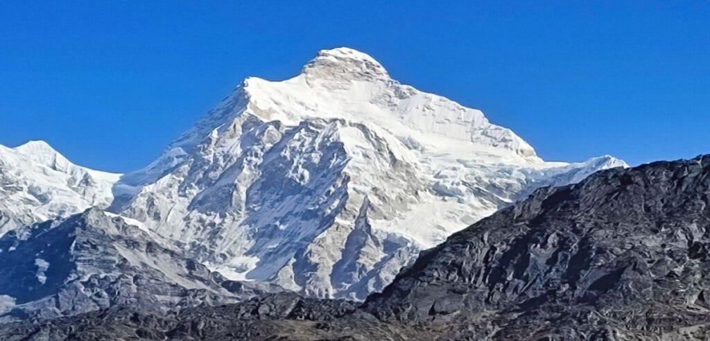 Mount Kanchenjunga standing at 8,586 meters viewed from a trekking route in Eastern Nepal